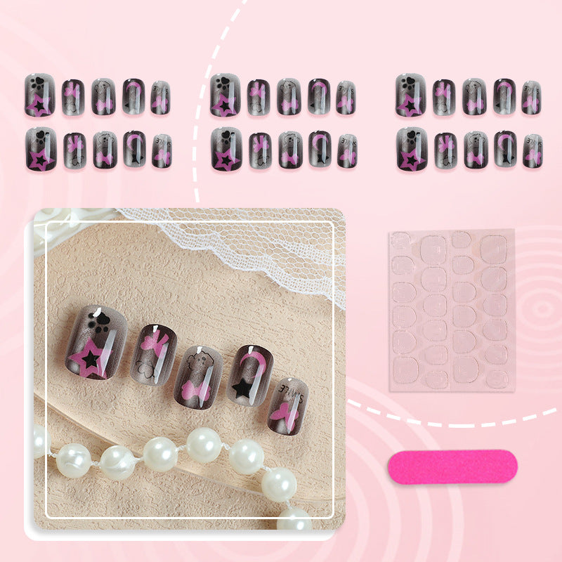 Künstlerisches Press-On Nagelset mit Stern- und Schleifenmotiven