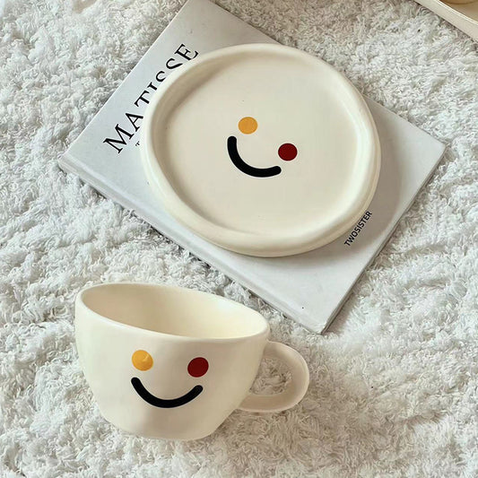Handgeformtes Keramik-Becher- und Teller-Set mit fröhlichem Smiley-Relief und organischer Form