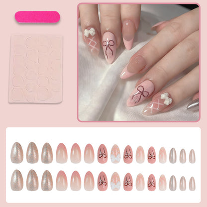 Kunstnagelset mit romantischen Schleifen- und Blumenverzierungen Brehn