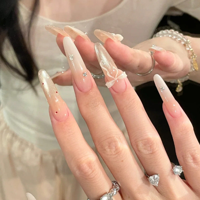 Elegante Stiletto Press-On Nägel mit dekorativem Bogen und Strassakzenten Brehn