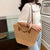 Handtasche mit Geflochtenem Design und Ledergriffen Brehn