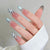 Elegantes Stiletto Press-On Nagelset mit einzigartigen Blumen- und Bandakzenten Brehn