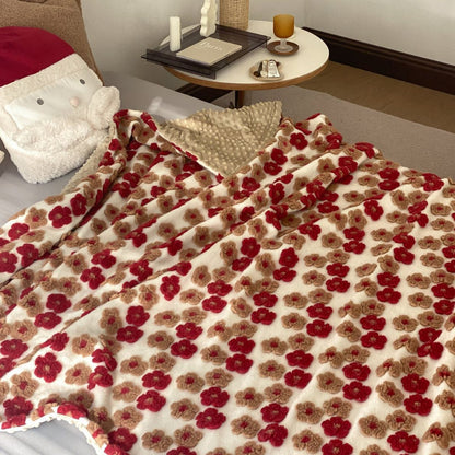 Gemusterte Wohndecke mit gewebten Blumenapplikationen