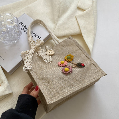 Blumennietete Jute-Handtasche