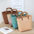 Handtasche Aus Geflochtenem Material mit Bambusgriffen Brehn