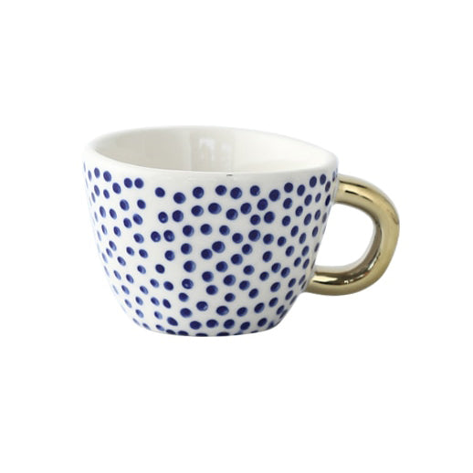 Tasse mit abstraktem geometrischen Muster und goldenem Henkel